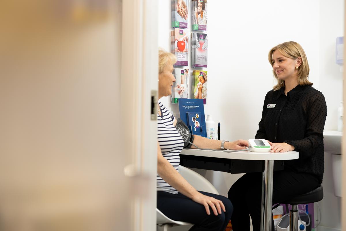 Patient having their blood pressure checked by pharmacist